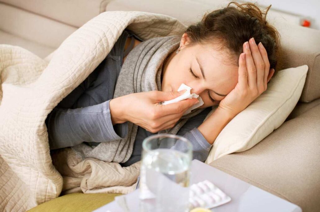 A woman blowing her nose